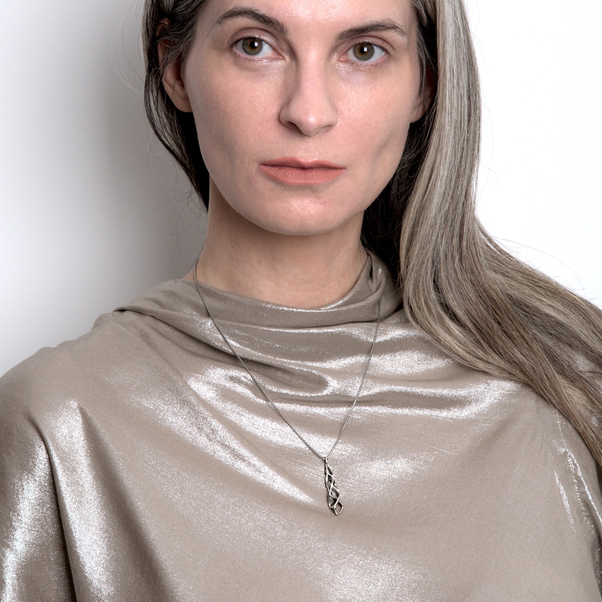 Our contrast oxidized solid sterling silver pendant necklace is styled with a metallic Rick Owens top. 