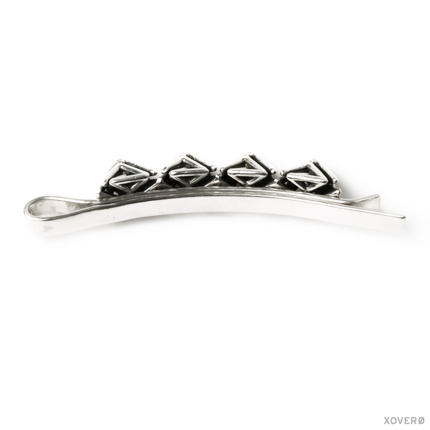 Back view of a hand formed and soldered sterling silver hair accessory topped with four detailed lattice spikes. 