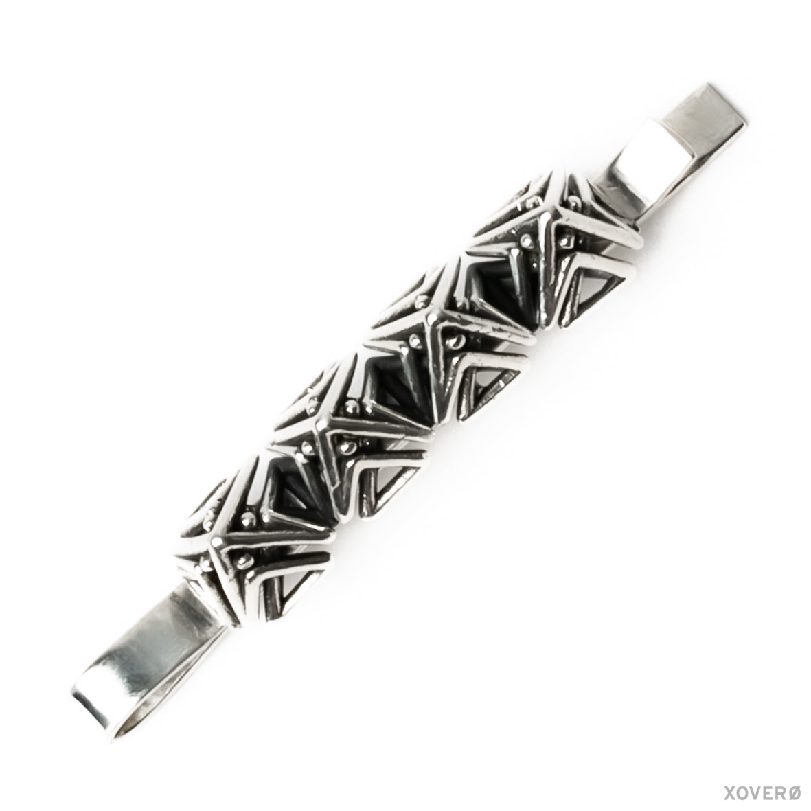 A sterling silver bobby pin with a geometric lattice of dense detailed angles forming pointed spikes.