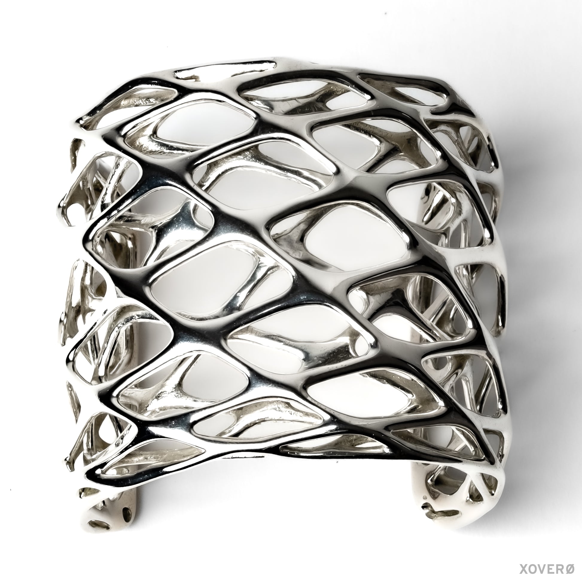 Tall dimensional sterling silver cuff bracelet with fluid angular lattice design. 