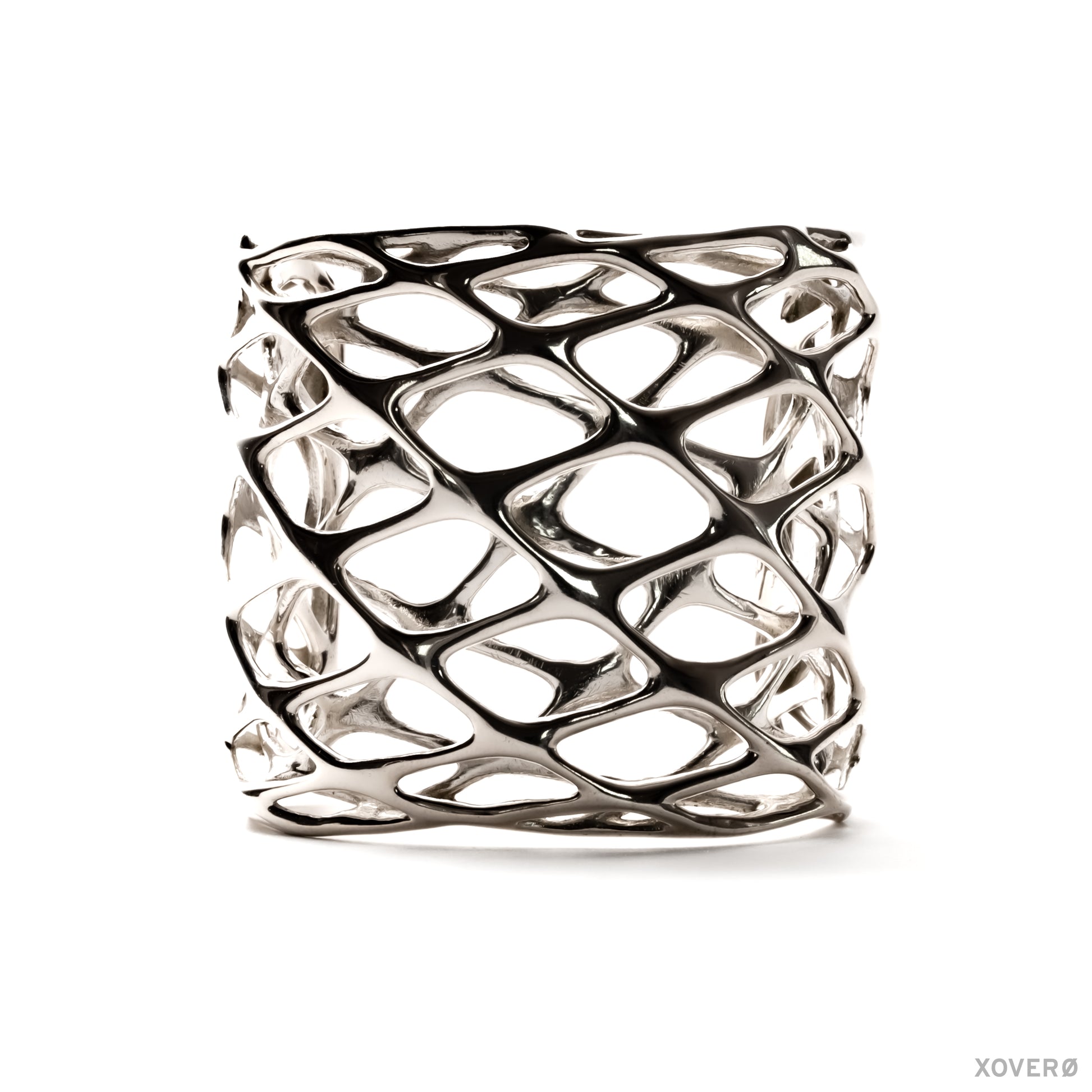 A tall, chunky sterling silver cuff bracelet with a layered geometric lattice pattern. The statement accessory has an angular edgy aesthetic. 