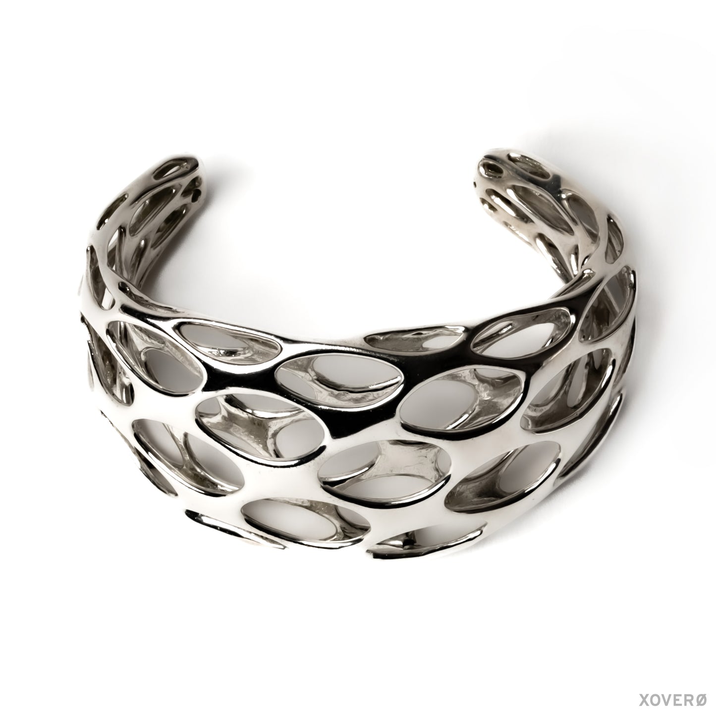 A chunky sterling silver cuff bracelet with a pattern of smoothly rounded cells, creating a net-like appearance.
