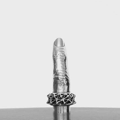 A sterling silver pendant in the shape of a human finger shown from all angles on a turn table. 